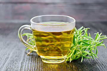 Image showing Tea of rosemary in cup on dark board