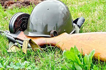 Image showing Helmet and submachine gun on grass