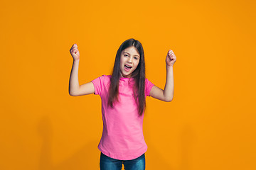 Image showing Happy success teen girl celebrating being a winner. Dynamic energetic image of female model