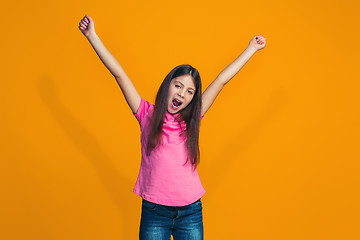 Image showing Happy success teen girl celebrating being a winner. Dynamic energetic image of female model