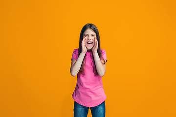 Image showing Isolated on pink young casual teen girl shouting at studio