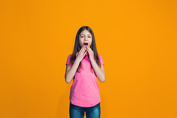 Image showing Beautiful teen girl looking suprised isolated on orange