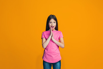 Image showing Isolated on pink young casual teen girl shouting at studio