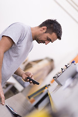 Image showing engineer in front of wood cutting machine