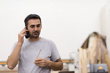 Image showing engineer in front of wood cutting machine