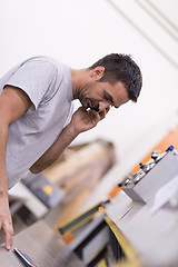 Image showing engineer in front of wood cutting machine