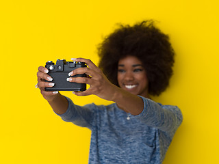 Image showing young african american girl taking photo on a retro camera