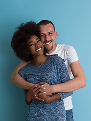 Image showing multiethnic couple laughing and hugging