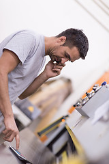 Image showing engineer in front of wood cutting machine