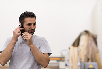 Image showing engineer in front of wood cutting machine