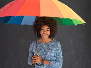 Image showing african american woman holding a colorful umbrella