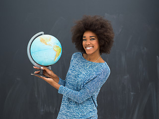 Image showing black woman holding Globe of the world