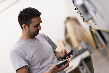 Image showing engineer in front of wood cutting machine