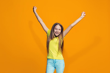 Image showing Happy success teen girl celebrating being a winner. Dynamic energetic image of female model