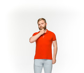 Image showing Closeup of young man\'s body in empty red t-shirt isolated on white background. Mock up for disign concept