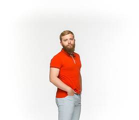 Image showing Closeup of young man\'s body in empty red t-shirt isolated on white background. Mock up for disign concept