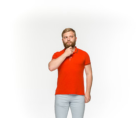 Image showing Closeup of young man\'s body in empty red t-shirt isolated on white background. Mock up for disign concept