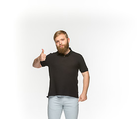 Image showing Closeup of young man\'s body in empty black t-shirt isolated on white background. Mock up for disign concept