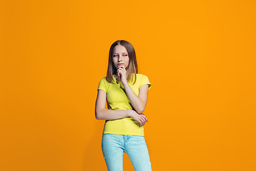 Image showing Beautiful teen girl looking suprised and bewildered isolated on orange