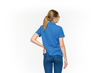 Image showing Closeup of young woman\'s body in empty blue t-shirt isolated on white background. Mock up for disign concept