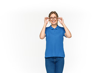 Image showing Closeup of young woman\'s body in empty blue t-shirt isolated on white background. Mock up for disign concept