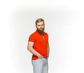 Image showing Closeup of young man\'s body in empty red t-shirt isolated on white background. Mock up for disign concept