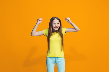 Image showing Happy success teen girl celebrating being a winner. Dynamic energetic image of female model