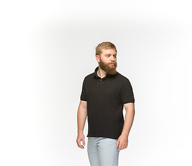 Image showing Closeup of young man\'s body in empty black t-shirt isolated on white background. Mock up for disign concept