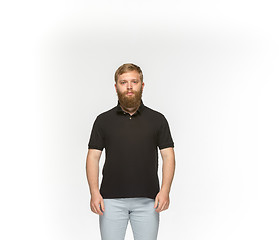 Image showing Closeup of young man\'s body in empty black t-shirt isolated on white background. Mock up for disign concept