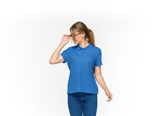 Image showing Closeup of young woman\'s body in empty blue t-shirt isolated on white background. Mock up for disign concept