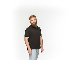 Image showing Closeup of young man\'s body in empty black t-shirt isolated on white background. Mock up for disign concept