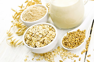 Image showing Oat flakes with flour and milk on board