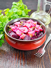 Image showing Salad of beets and potatoes with oil in bowl on board