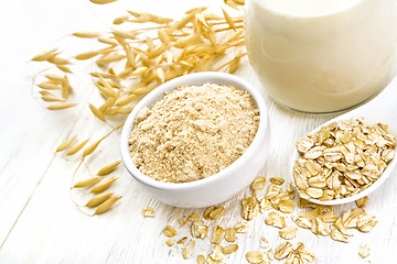 Image showing Flour oat in bowl with milk on board