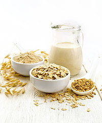 Image showing Oat flakes with flour and milk on white board