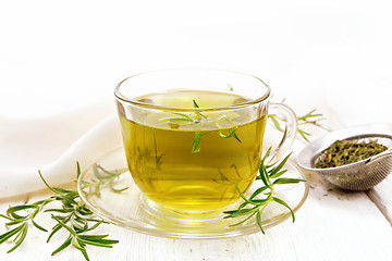 Image showing Tea of rosemary in cup with napkin on board