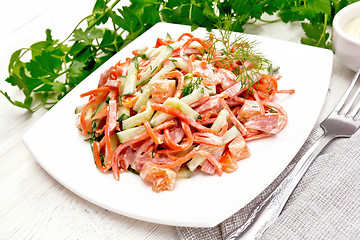 Image showing Salad of sausage and spicy carrots with mayonnaise on board