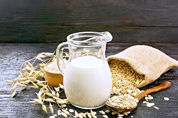 Image showing Milk oatmeal in jug on board