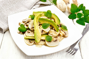 Image showing Salad of avocado and champignons on light table