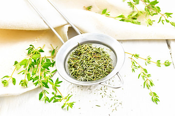 Image showing Thyme fresh and dry in strainer on light board