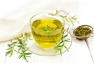 Image showing Tea of rosemary in cup with napkin on light board