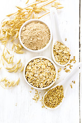 Image showing Oat flakes with flour and grain on board top