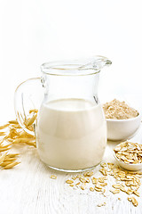 Image showing Milk oatmeal in jug on light board