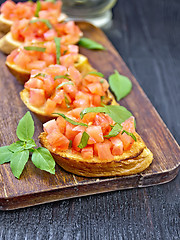 Image showing Bruschetta with tomato and basil on table