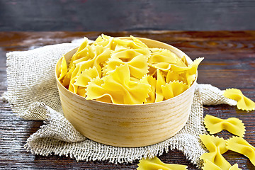 Image showing Farfalle in bark box on wooden board