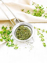 Image showing Thyme fresh and dry in strainer on board