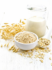Image showing Flour oat in bowl with milk on light board