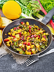 Image showing Mangold braised in pan on wooden board