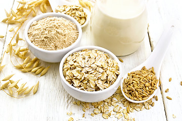 Image showing Oat flakes with flour and milk on table