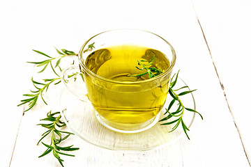 Image showing Tea of rosemary in cup on light board